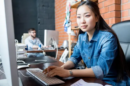 Woman typing at computer