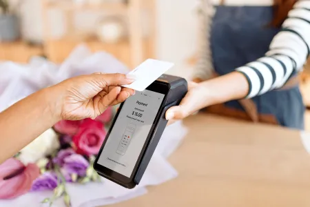 Person using card for contactless payment on payment terminal