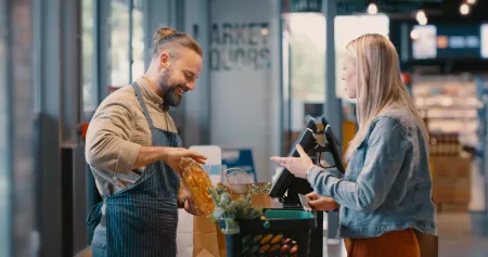 Woman checking out at grocery store