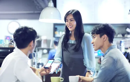 Payment at table_SoftPOS_Asian woman is having a tablet in the hand.png