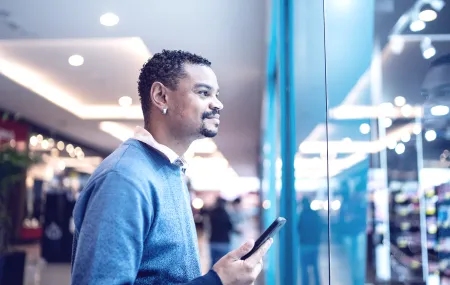 Retail_Young man looking at store window at the mall_0.png