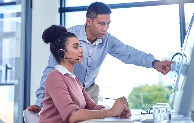 Estate Management_Two people with headset discussing in front of the computer_v2.png